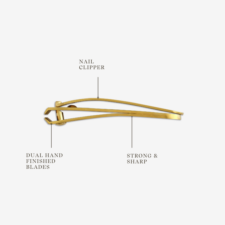 A nail clipper with a gold coating and dual hand-finished blades.