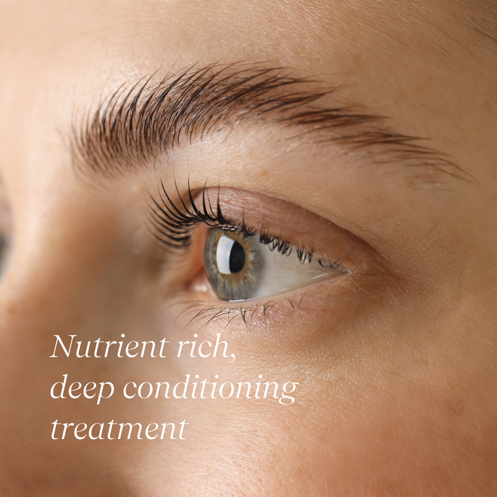 A bottle of Conditioning Lash & Brow Serum with a brush applicator. Supports tihicker, stronger lashes.Vegan. Ethically Sourced. Cruelty Free