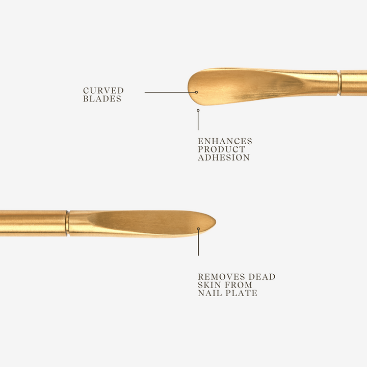 Gold curved manicure tool for nail prep.
