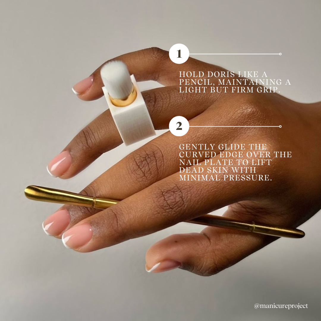 Gold curved manicure tool for nail prep.