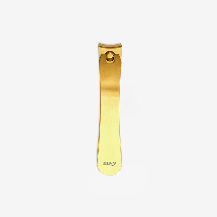 A nail clipper with a gold coating and dual hand-finished blades.