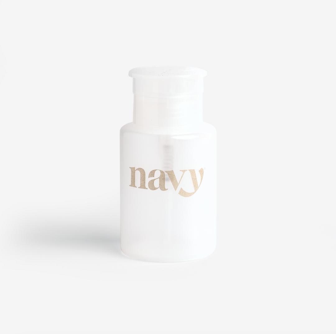 A white refillable pump bottle with the brand name 'navy' printed on it against a light background.