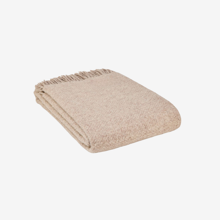 Beige blanket with fringes on a white background