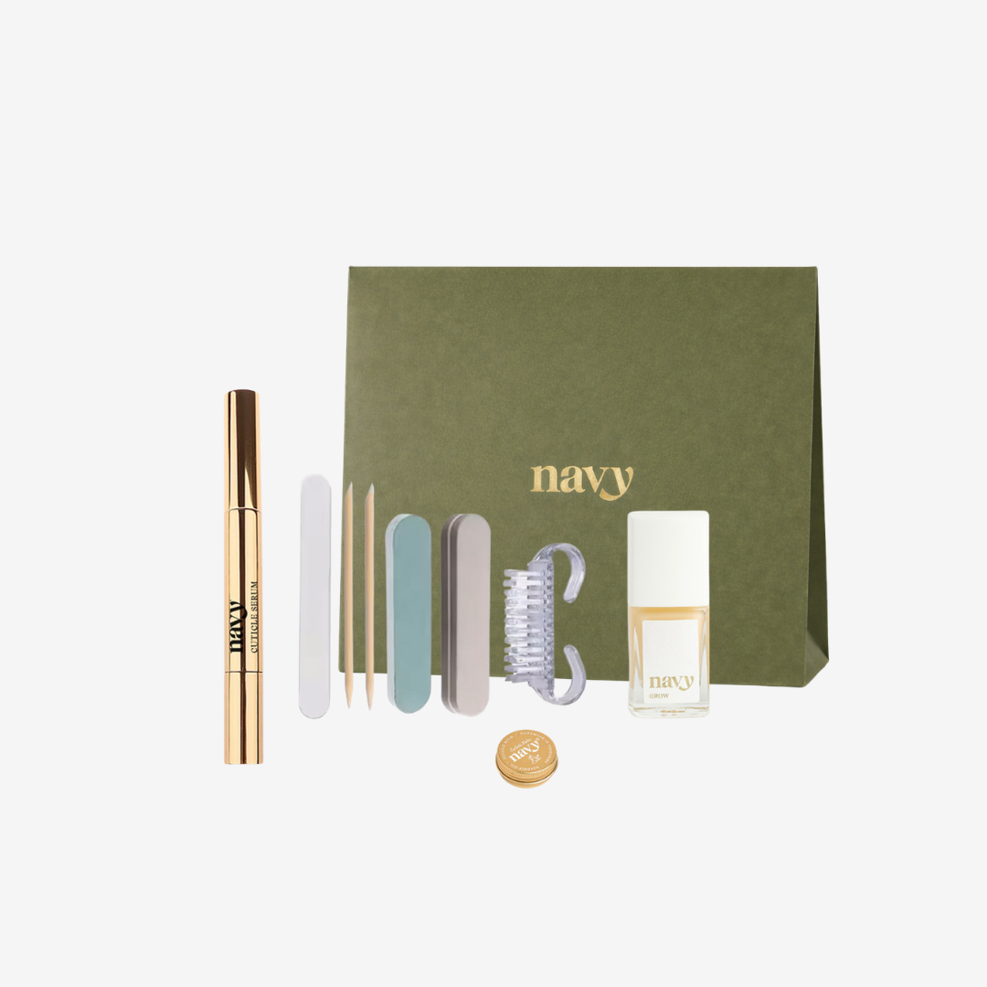 Set of beauty products including a mascara, brush, and small bottles with a green box labeled 'navy' on a white background.