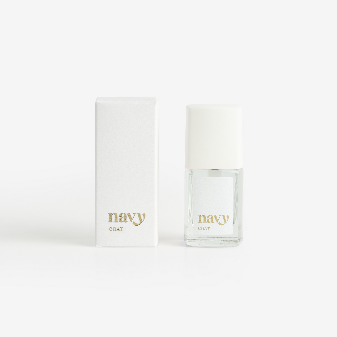 A bottle of Navy Coat nail treatment positioned next to its packaging box, both featuring the brand name 'navy'.