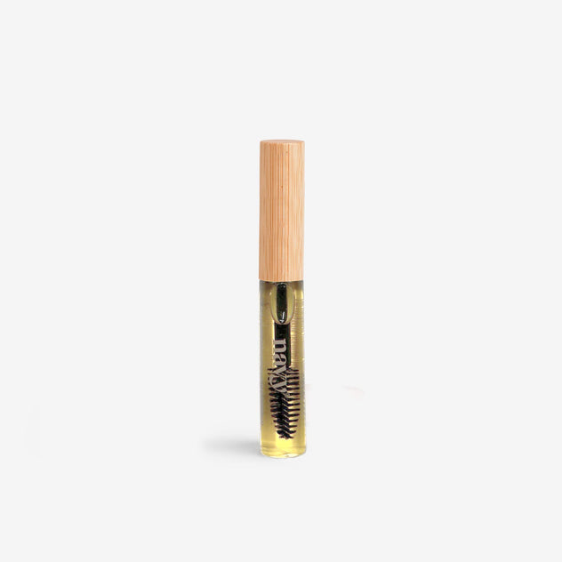 A bottle of Conditioning Lash & Brow Serum with a brush applicator. Supports tihicker, stronger lashes