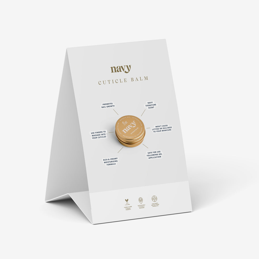 A tent-style A5 point of sale display card for Navy Cuticle Balm with a gold lid product image, set against a white background.