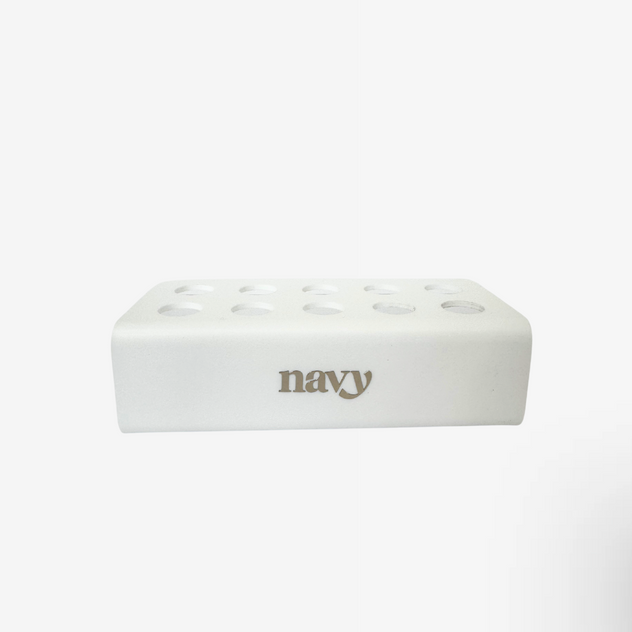 White acrylic retail stand with 'navy' branding on