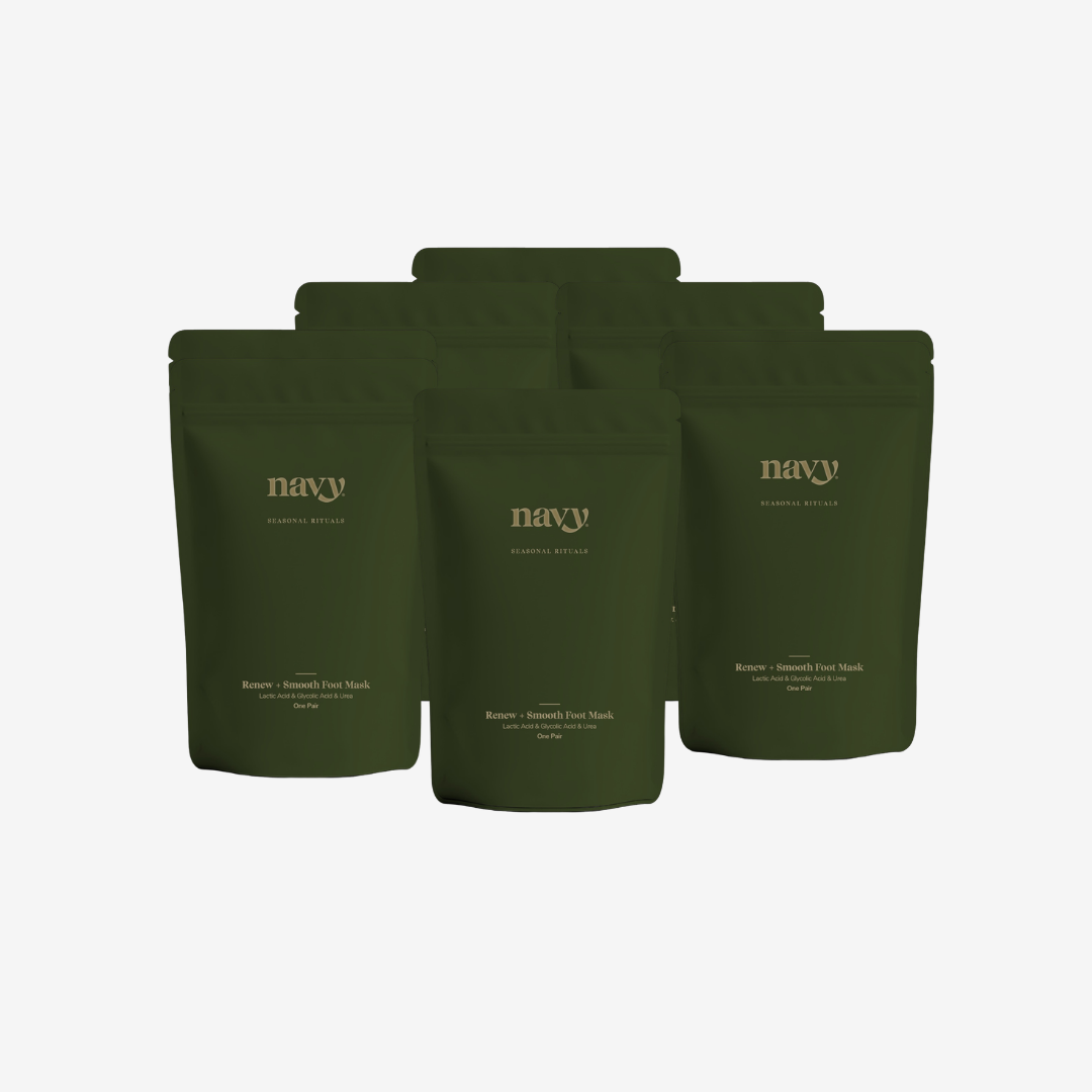 Five dark olive green stand-up pouches of 'navy' brand coffee bags arranged in a fan shape against a light gray background.
