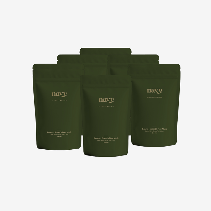 Five dark olive green stand-up pouches of 'navy' brand coffee bags arranged in a fan shape against a light gray background.