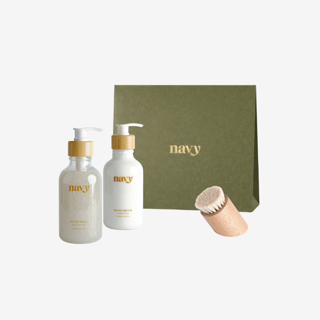 Two bottles labeled 'navy' with a green box and a wooden scrubber on a white background.