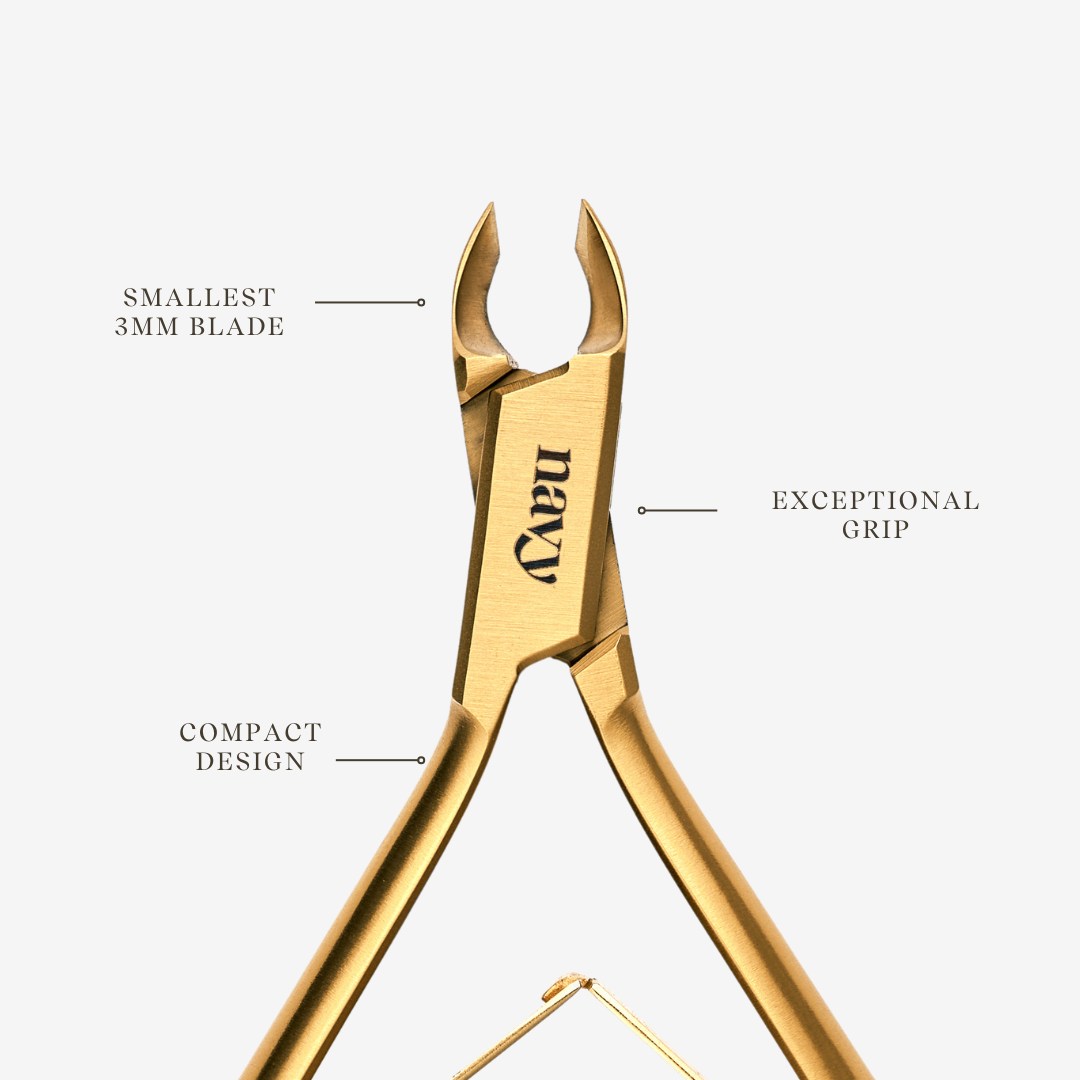 Gold nail clippers nippers with features labeled on a white background