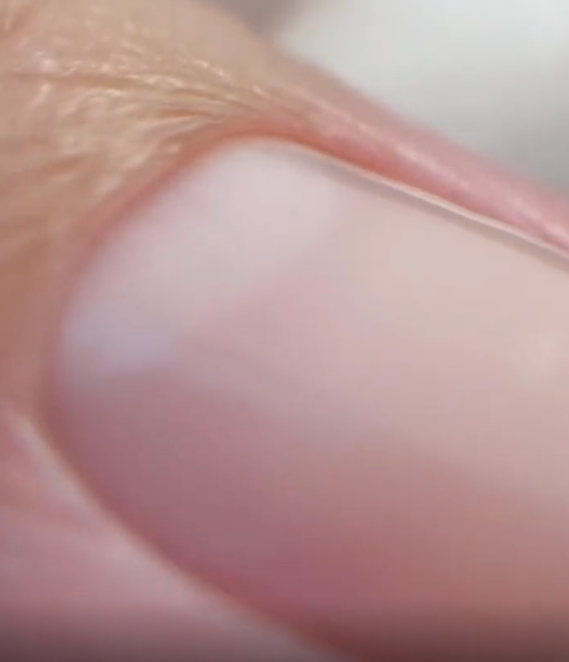Close-up of a person's finger with a blurred background