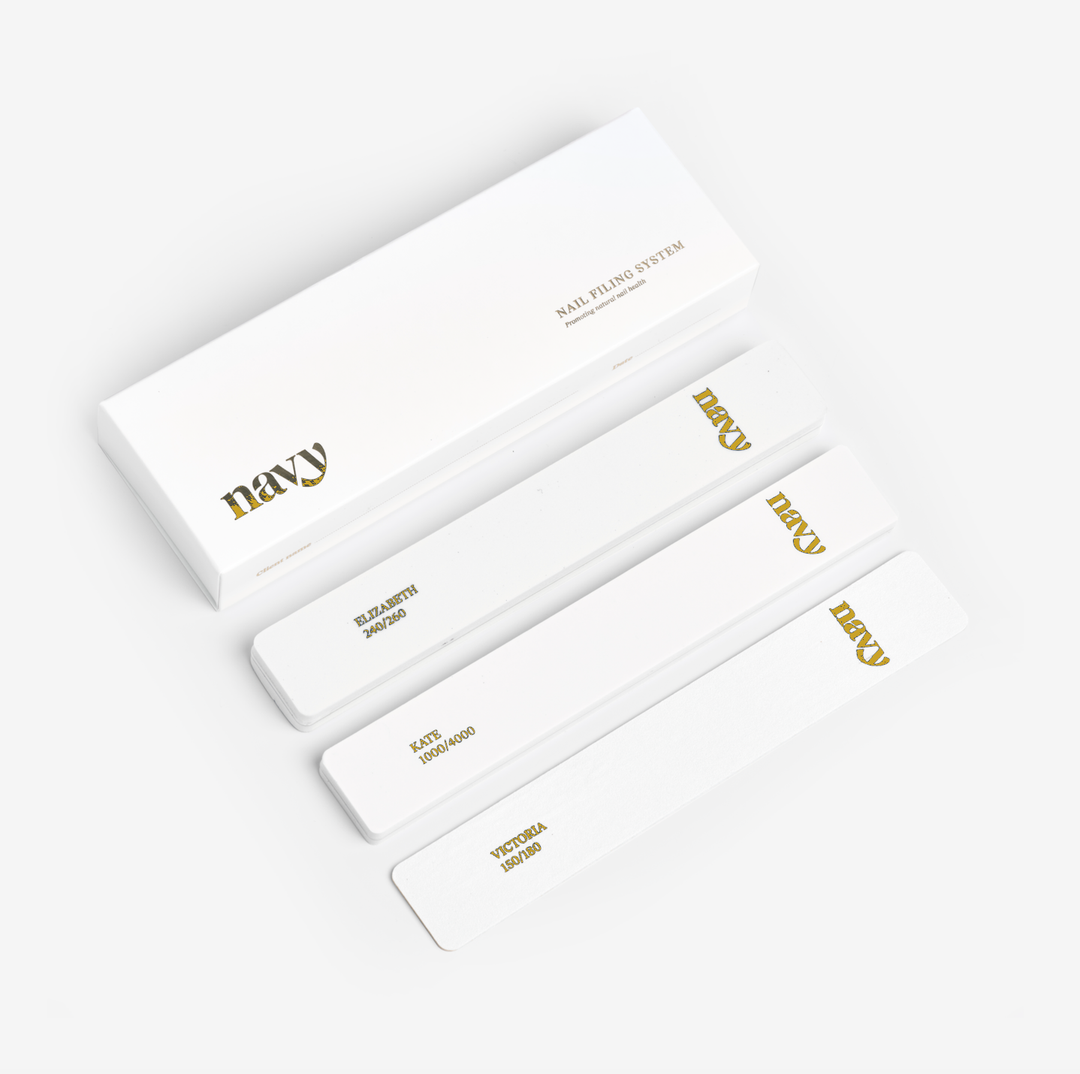 Set of white nail files with gold text on a white background