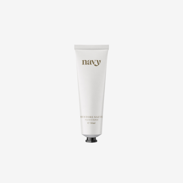 White tube of 'navy' balm on a white background