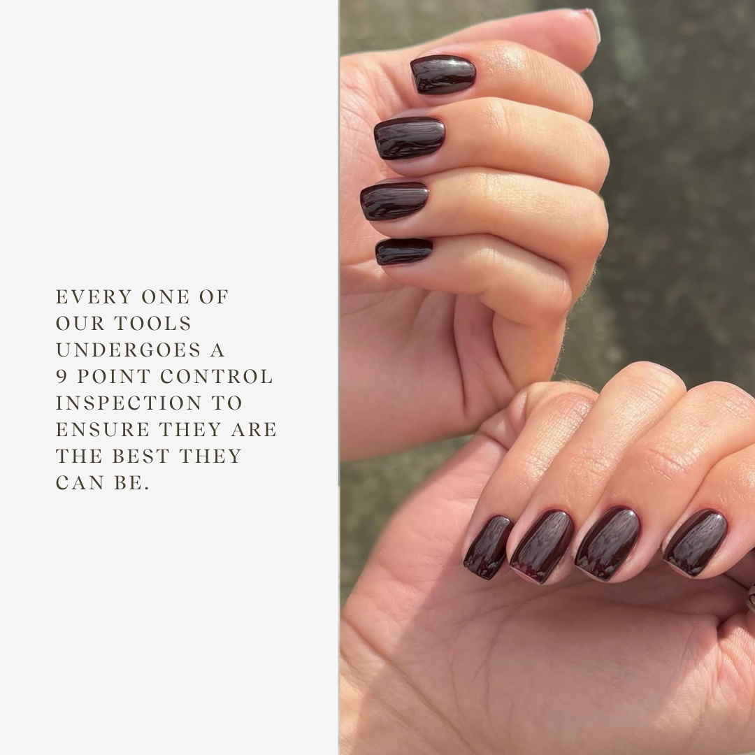 Close-up of hands with dark nail polish against a neutral background