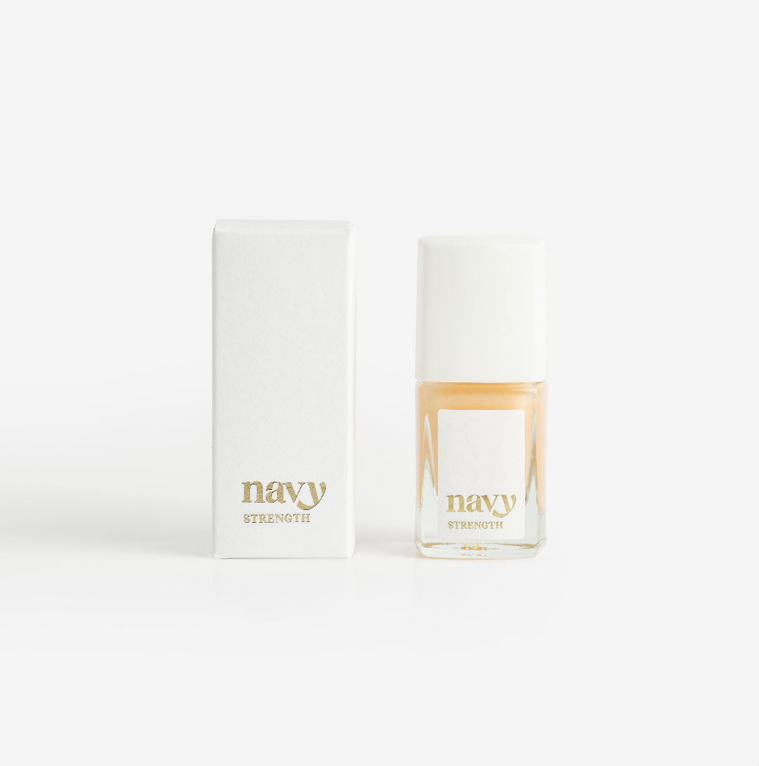 A bottle of Navy Strength nail treatment polish next to its packaging box, both with the brand name visible.