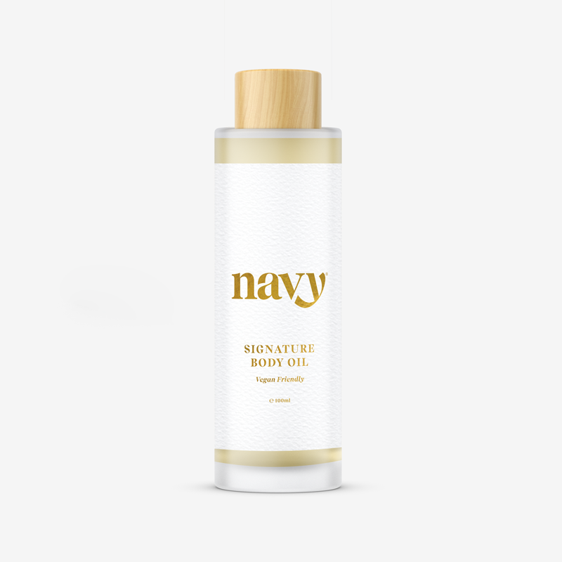  Navy Signature Body Oil,  with white labels and gold text, containing natural seed oils for hydration.
