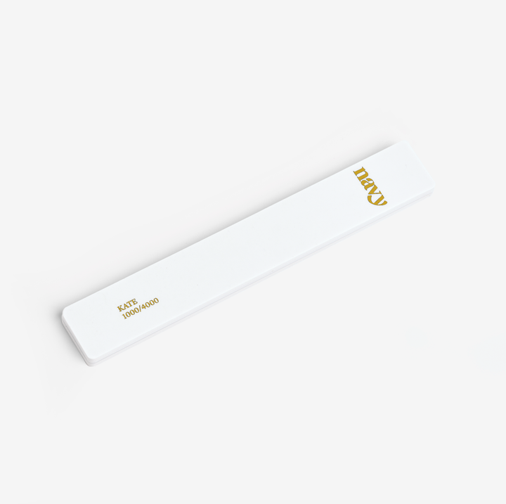 White nail file  with gold text on a white background