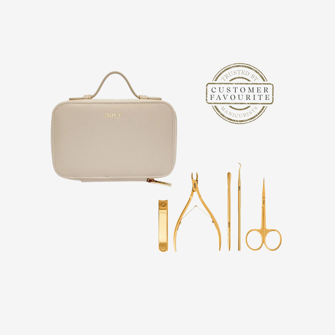 Beige travel case with gold nail care tools on a white background