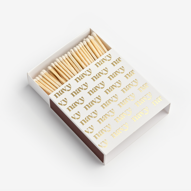 A white box of matches with gold text and logo, containing light brown matches.
