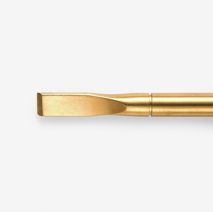 A gold-colored nail removal tool. Designed for the removal of gel and acrylic nail products.