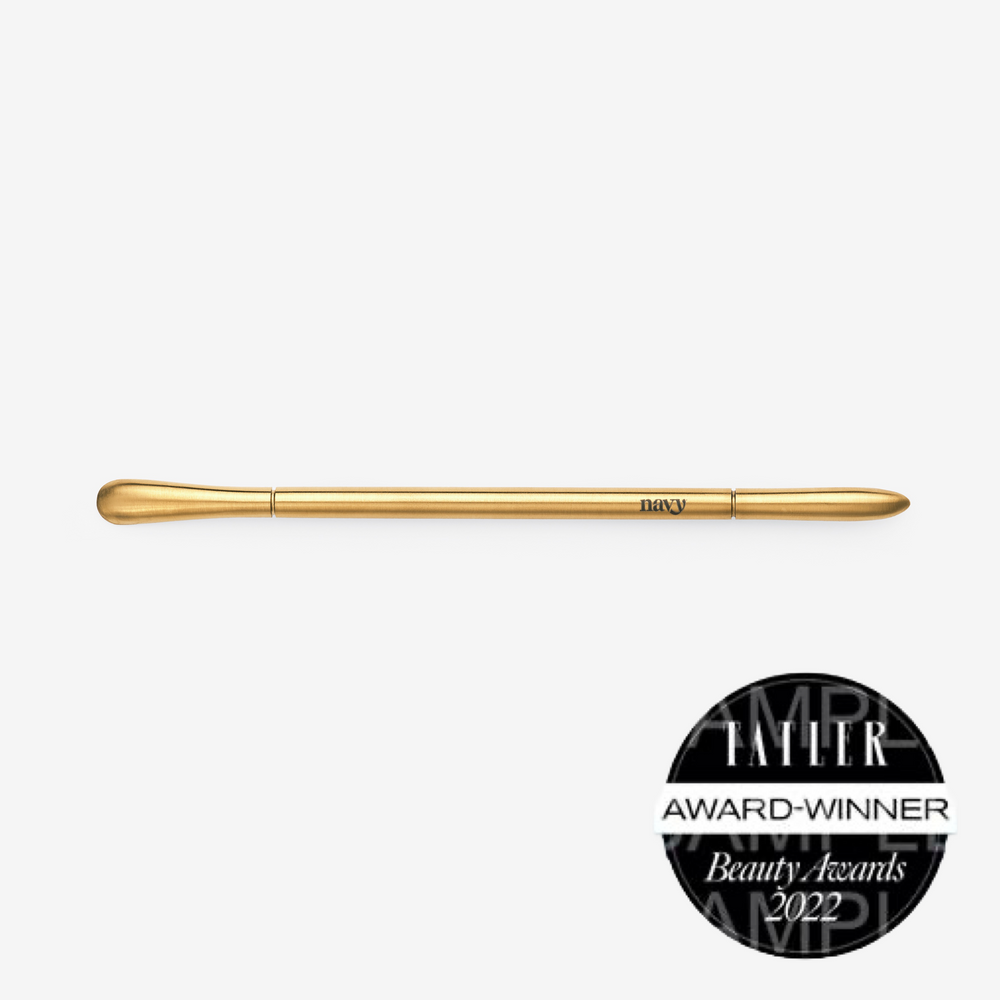 A gold-colored curved manicure tool with a titanium coating, awarded at the TATLER Beauty Awards