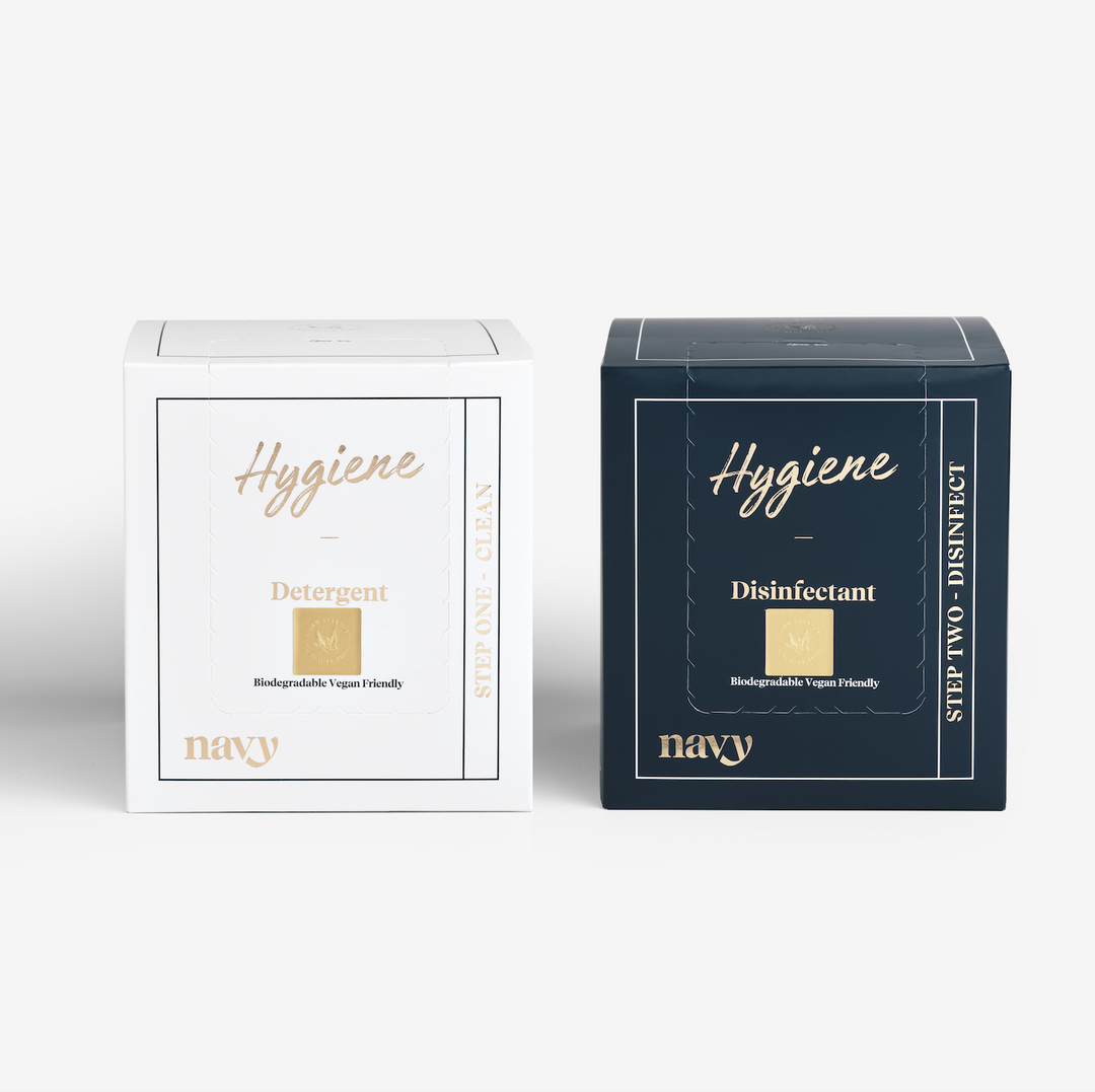Two boxes of Navy Professional hygiene kit, one labeled 'Hygiene' with a gold and white colour scheme, and the other 'Disinfectant' with a navy and gold colour scheme.