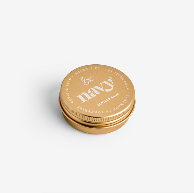 A gold-colored 30ml aluminum tin of Navy Cuticle Balm with the brand name 'Navy' displayed on the lid.